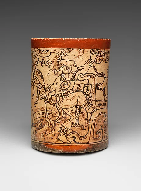 Vase cylindrique à bord rouge, couvert de personnages et de signes peints en noir sur fond clair.